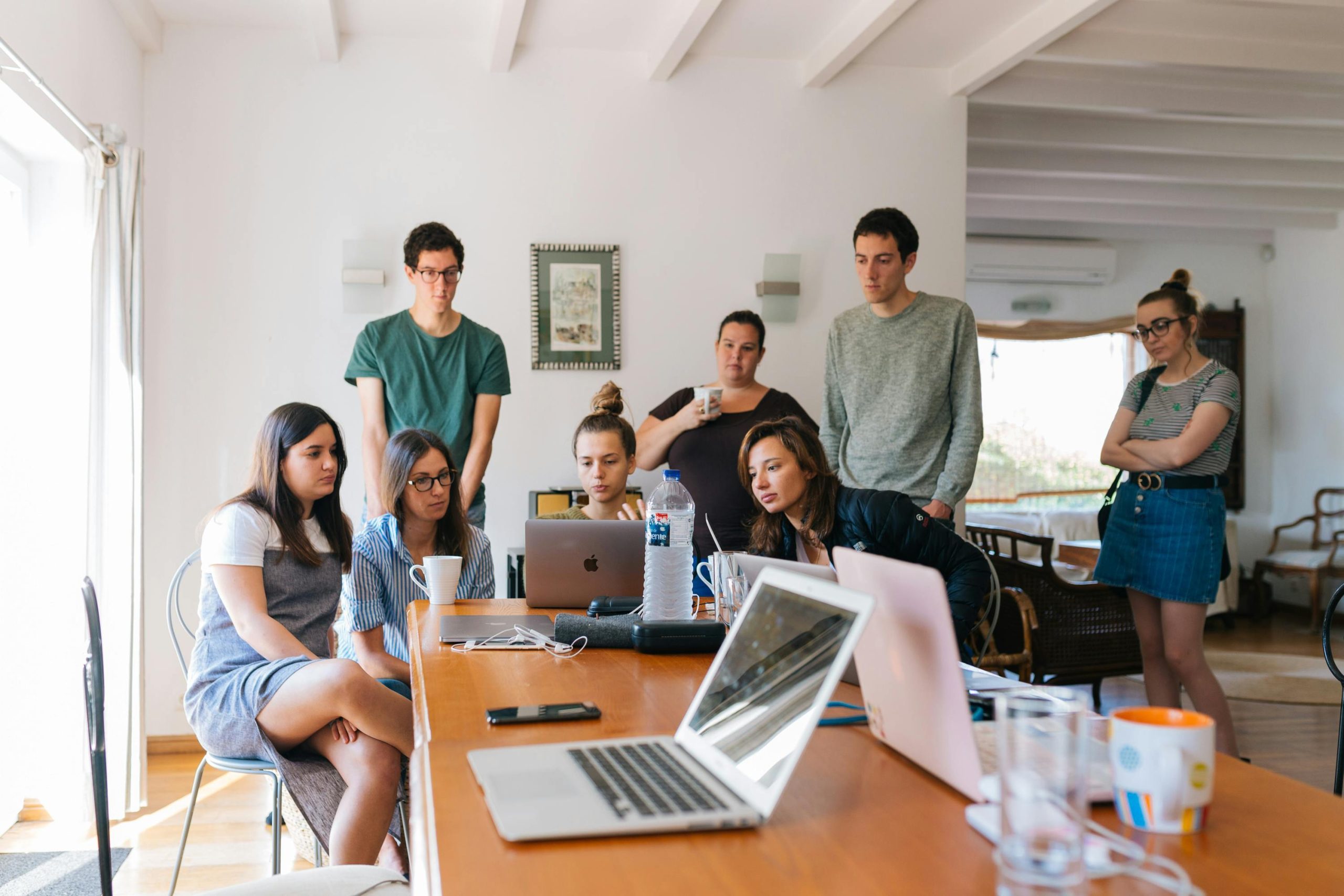 A picture of a group of people standing around in an office